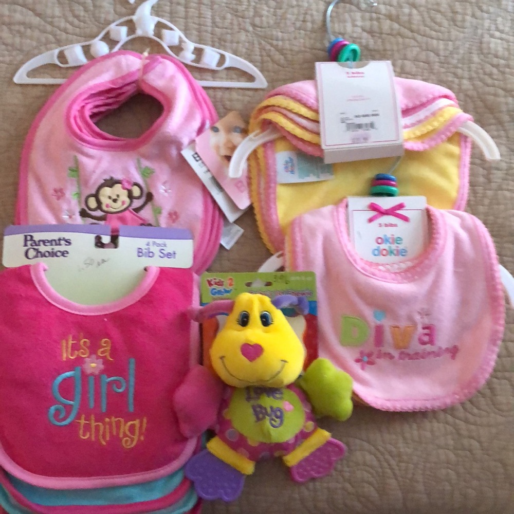 NWT….24 baby bibs and 3 soft baby toys.  Okie Dokie, Garanimal, Baby Essentials.
